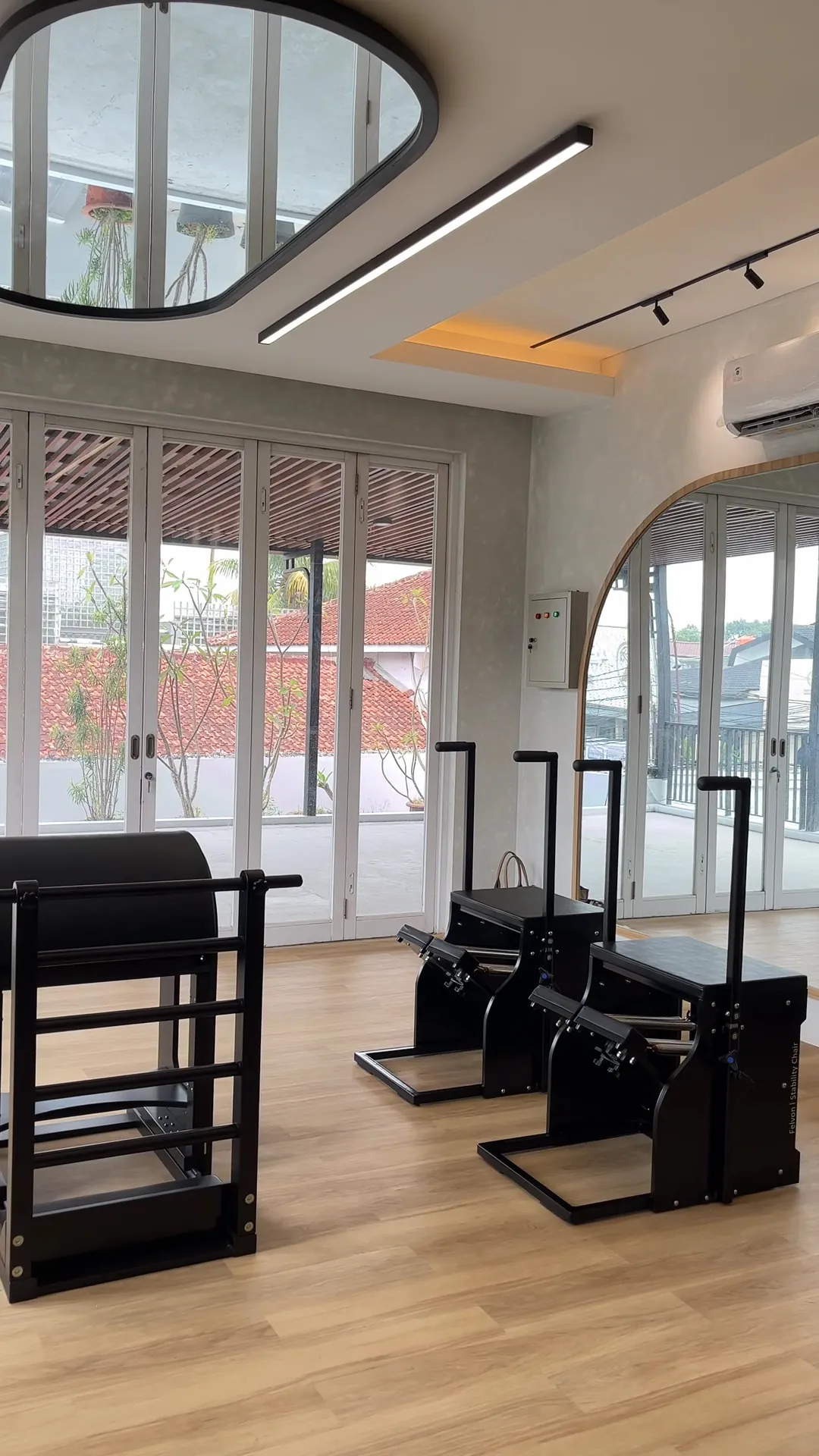 Stability chairs and towers in front of tall white windows